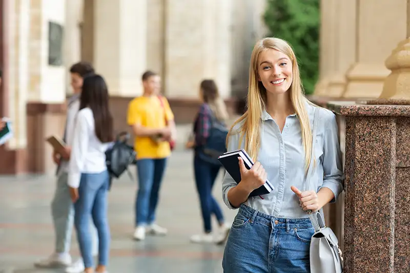 Young woman on a college campus representing egg donation options and donor eligibility for intended parents working with Global Surrogacy Services.