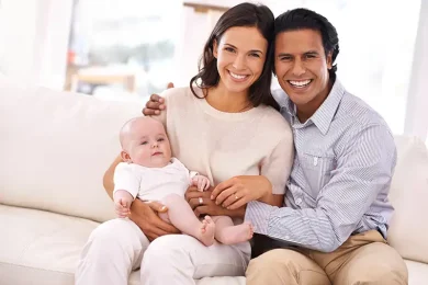 Intended parents with their baby after receiving additional surrogacy support and coordination